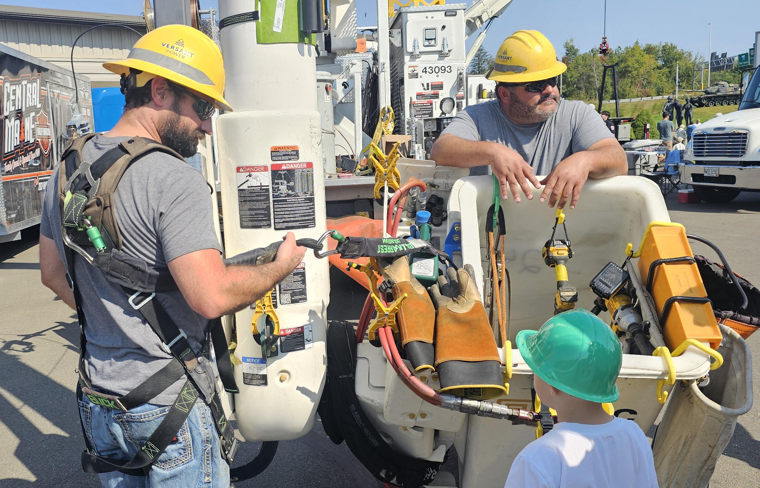two workers showing a child safety gear