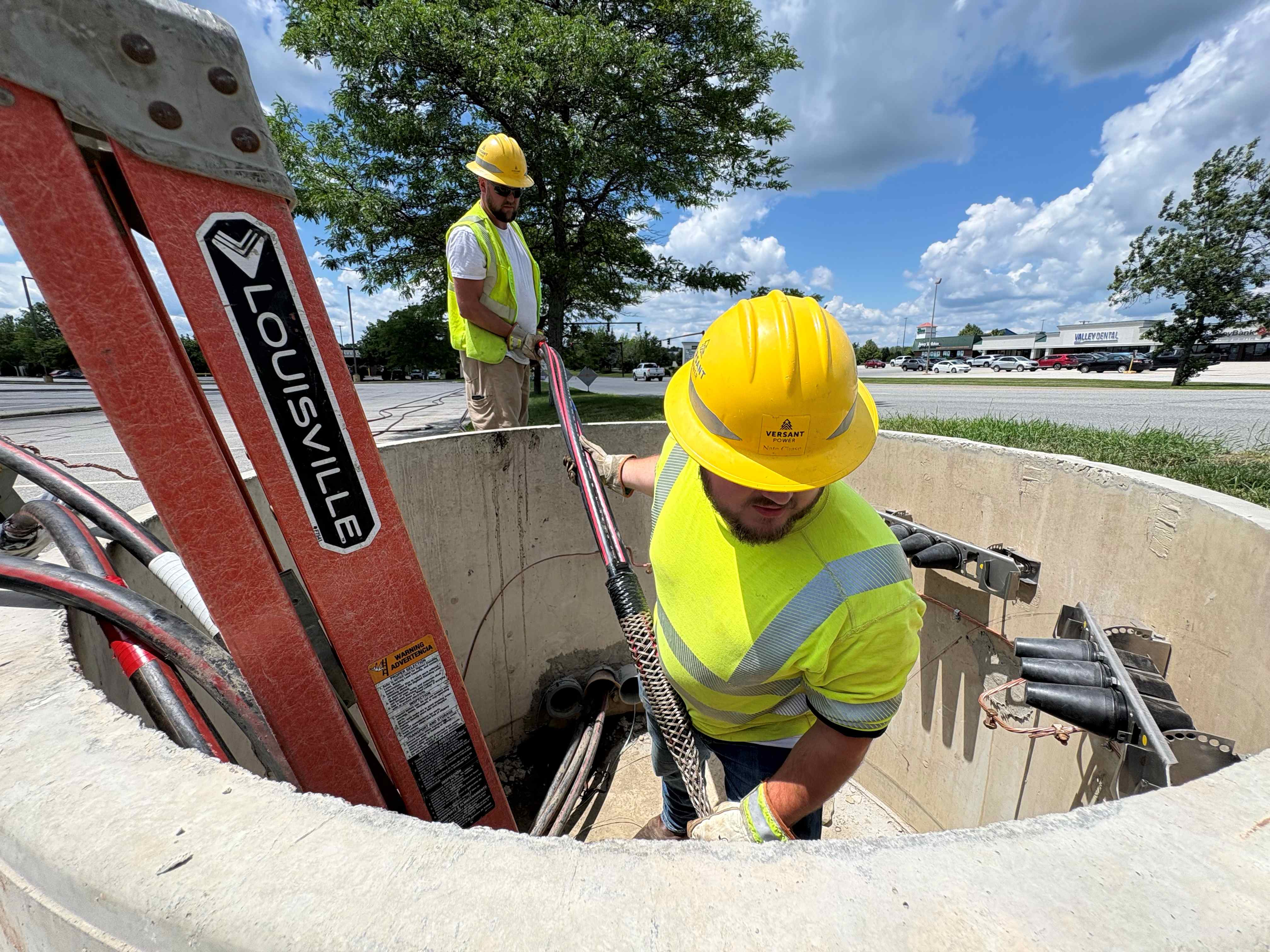 two people working with power lines
